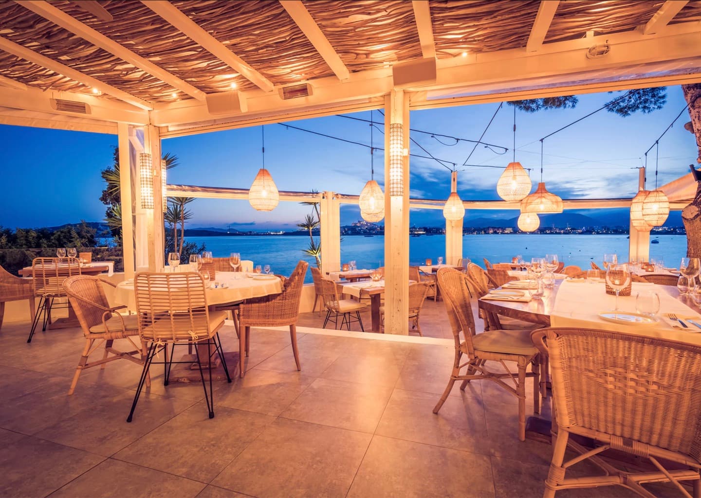 The terrace at Sa Punta over Talamanca Bay at dusk, Ibiza